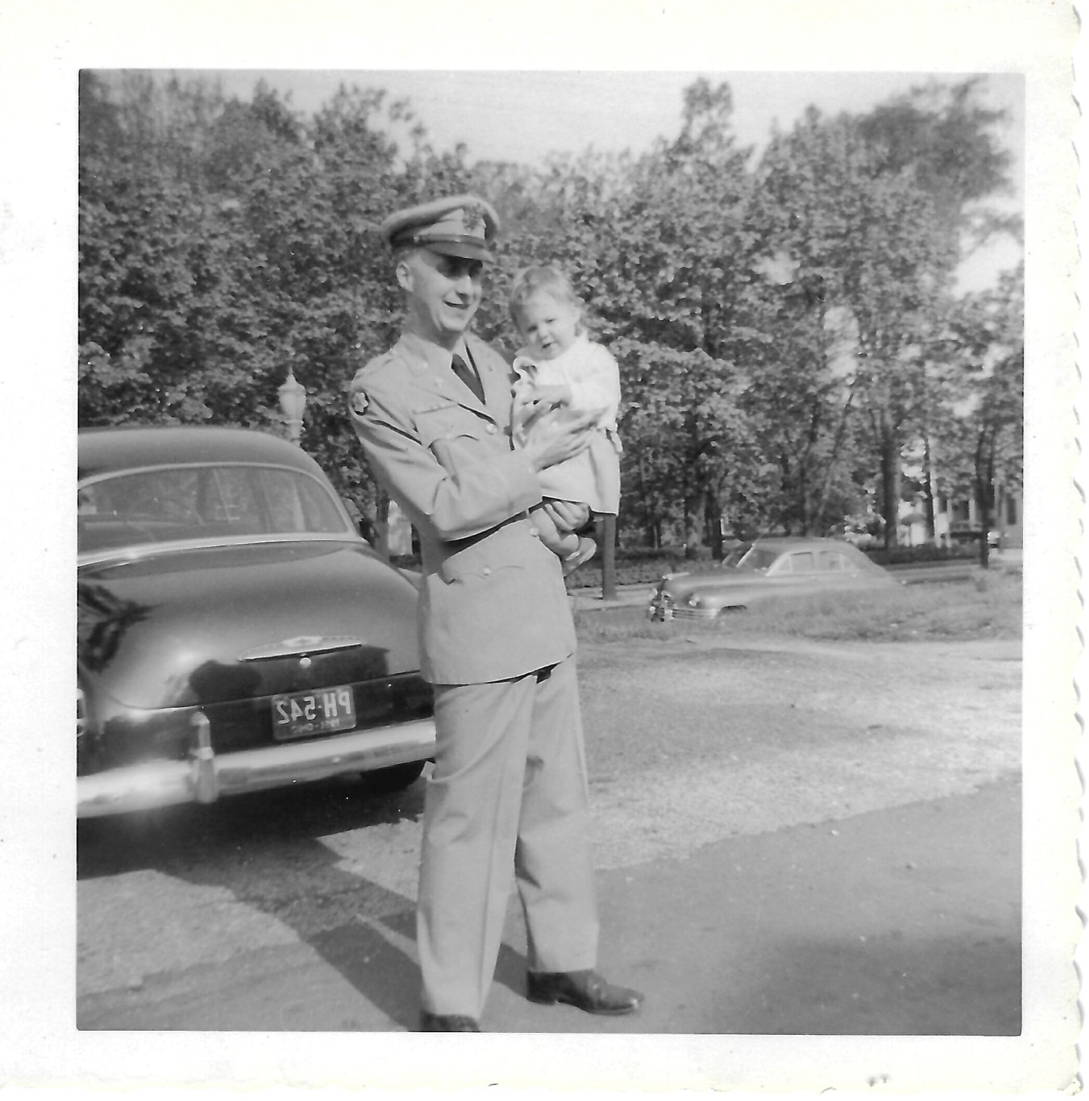 Jack and Betty beside a car