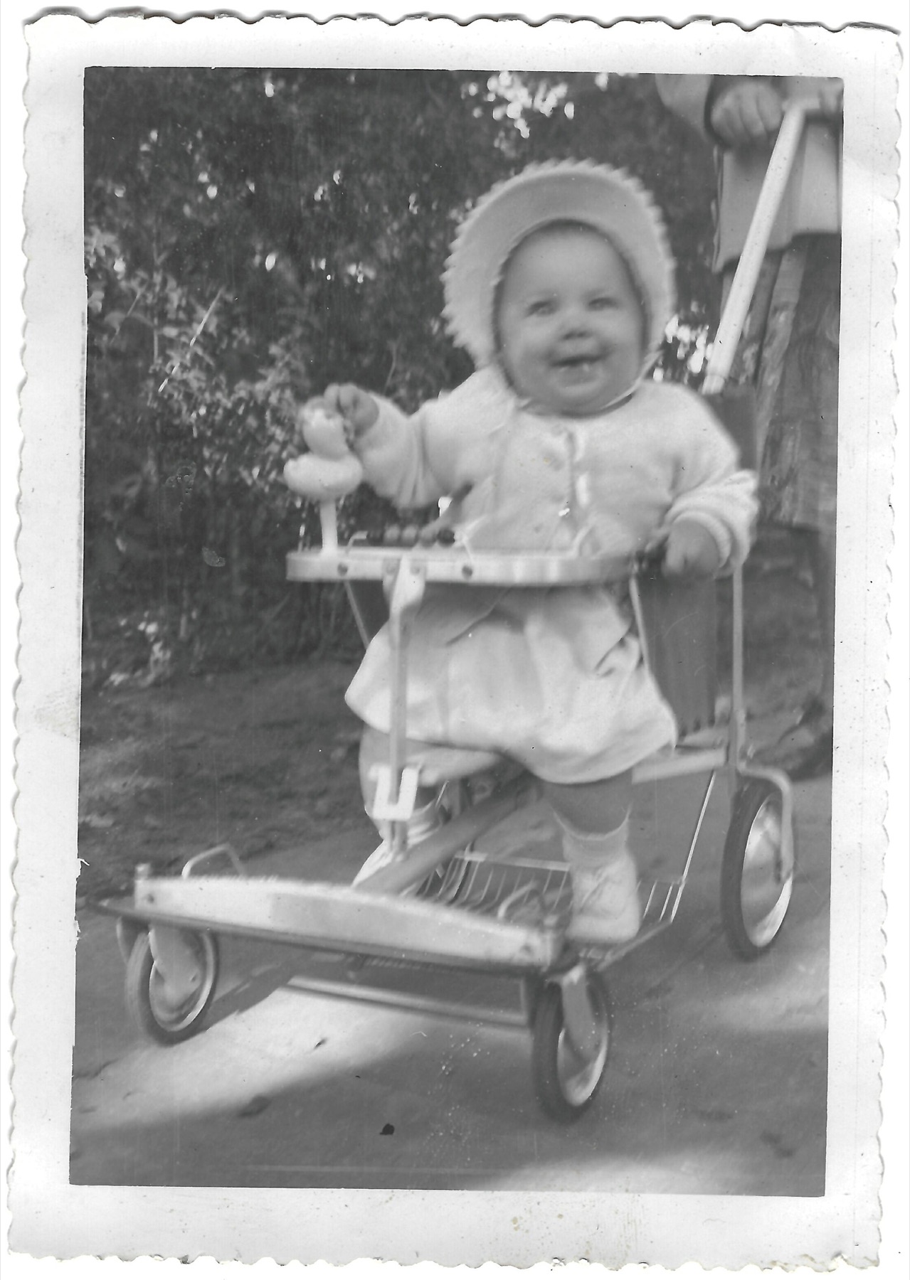 Young Betty standing in her stroller