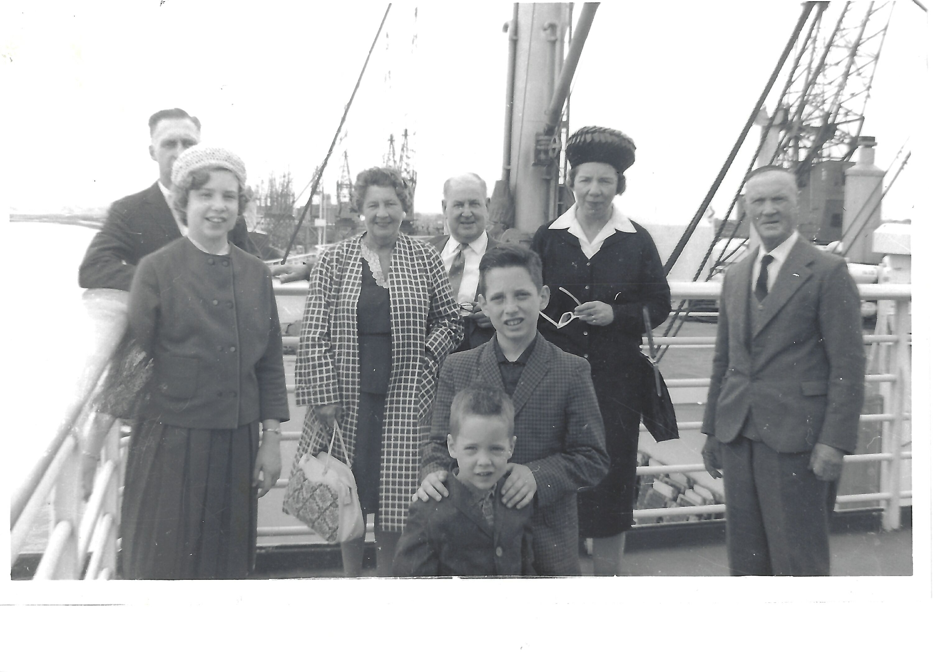 A group aboard a ship. Individual identities, date, and voyage direction remain unconfirmed.