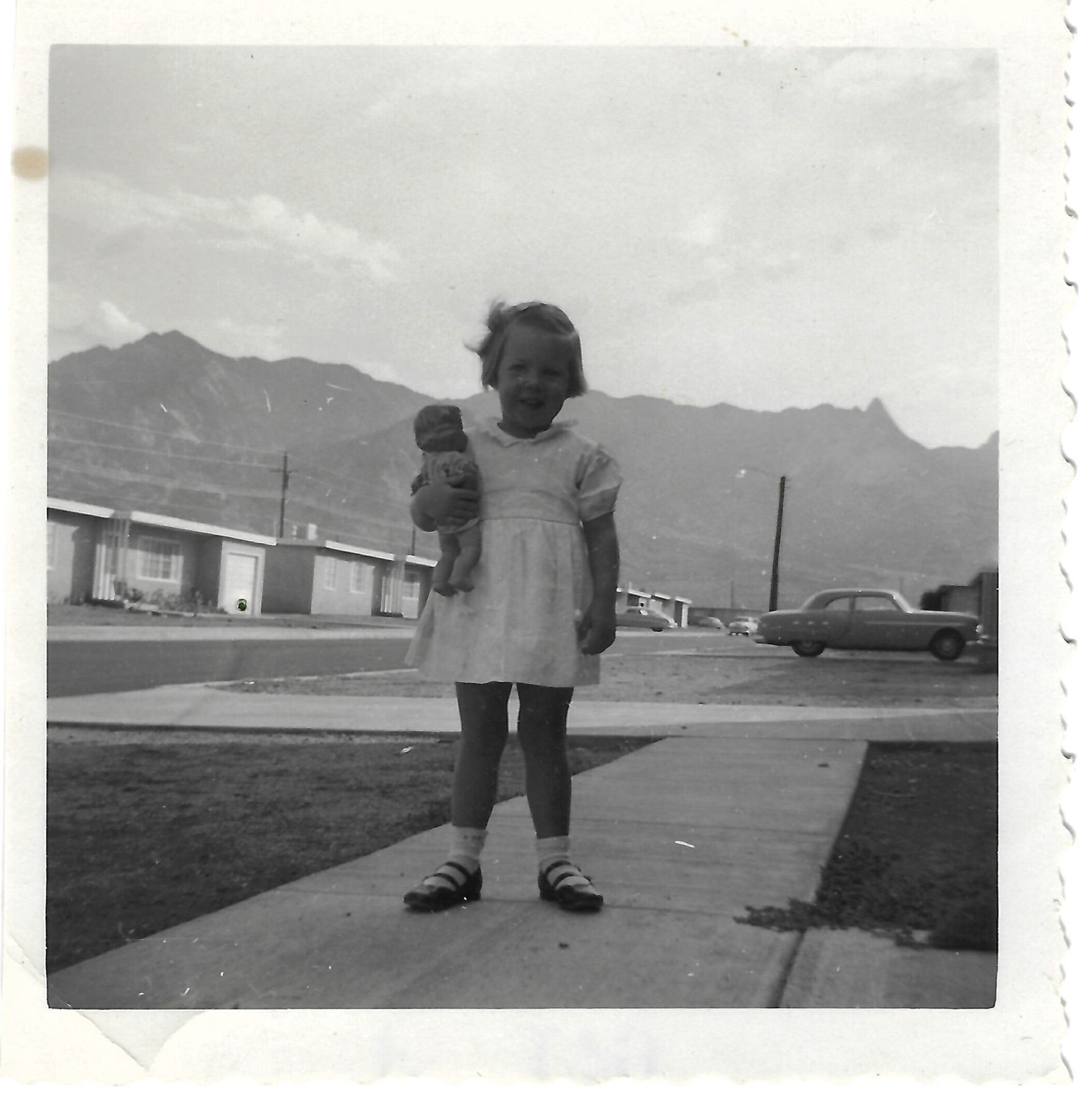 Betty with a doll at White Sands, New Mexico