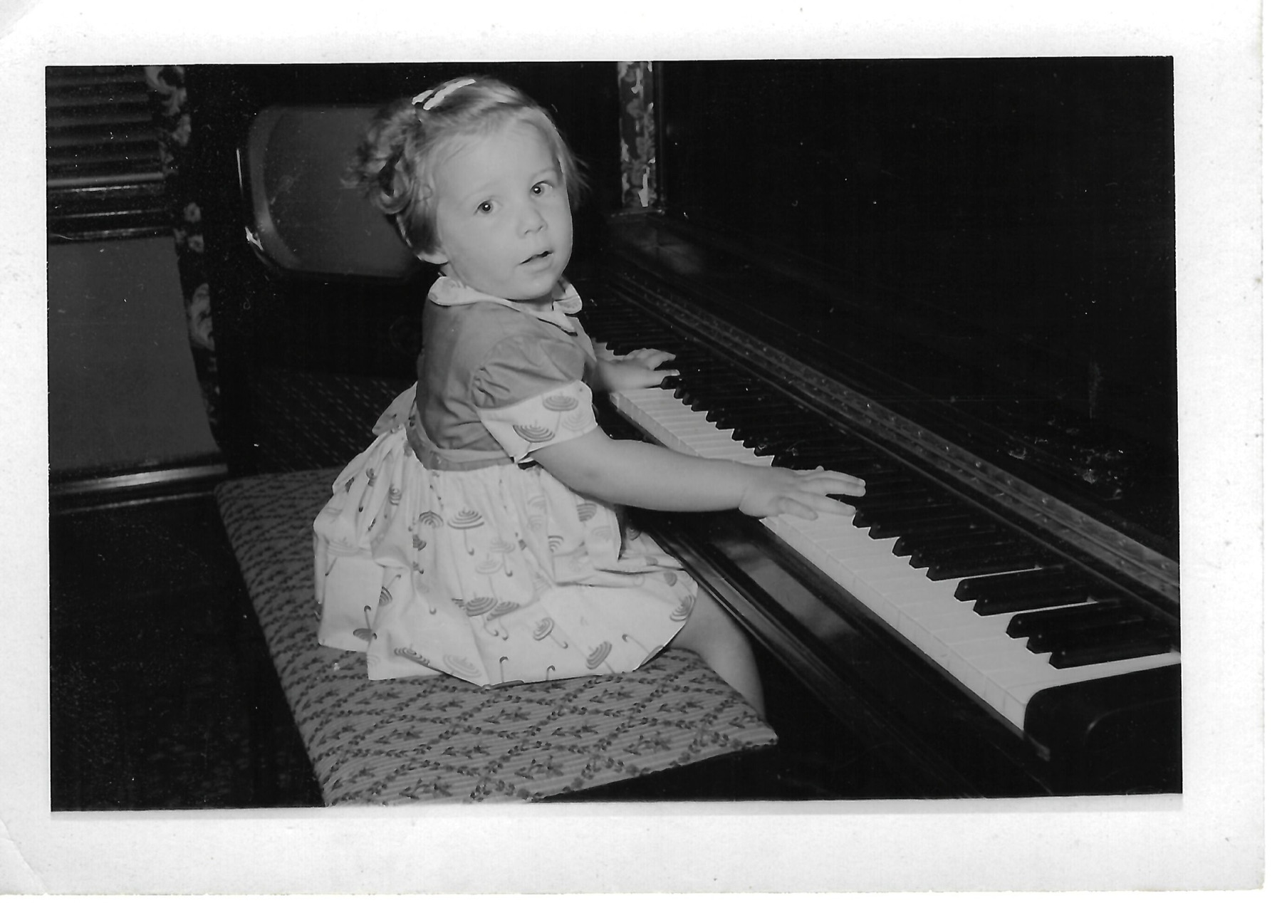 Young Betty seated at a piano; date not confirmed