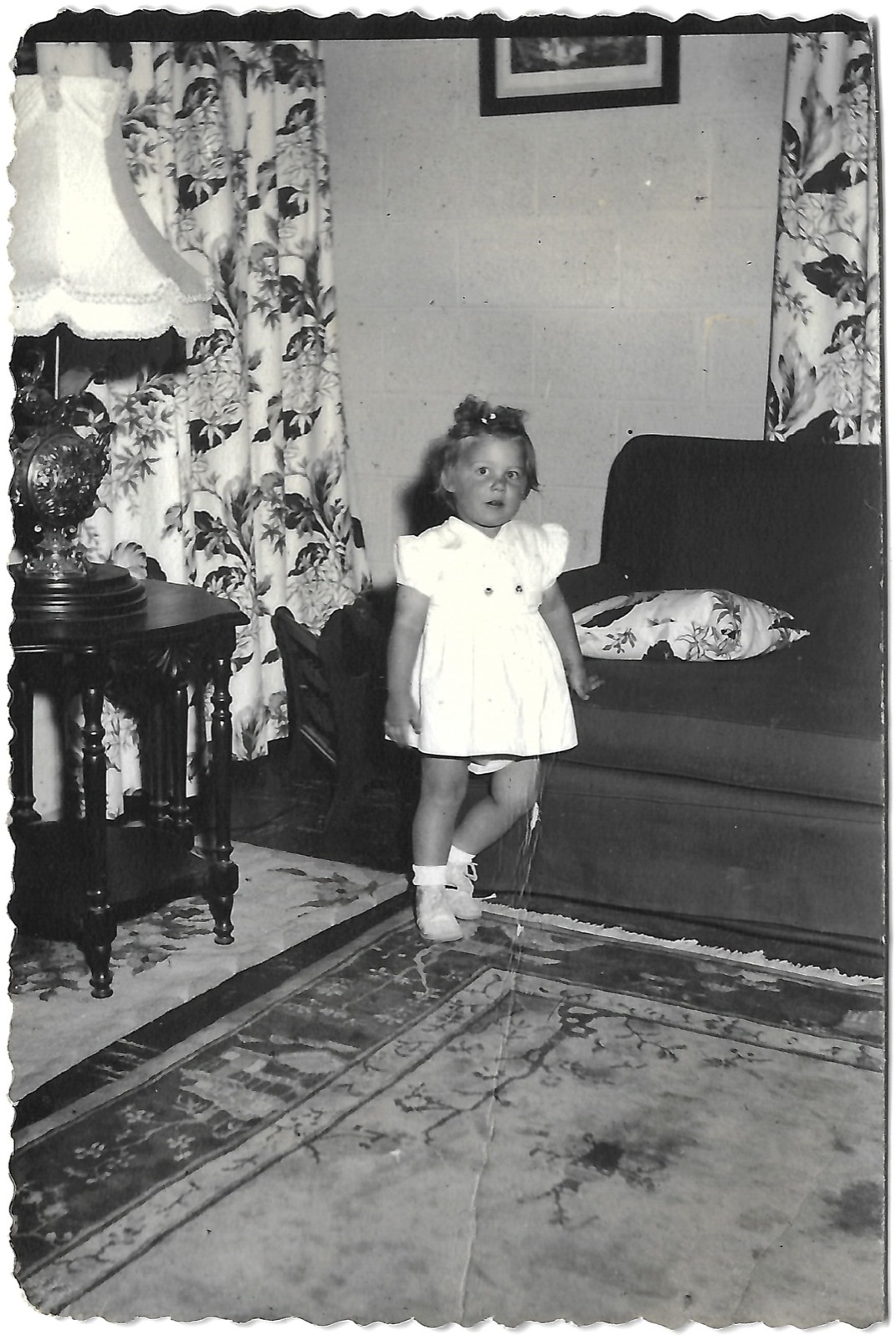 Young Betty standing indoors
