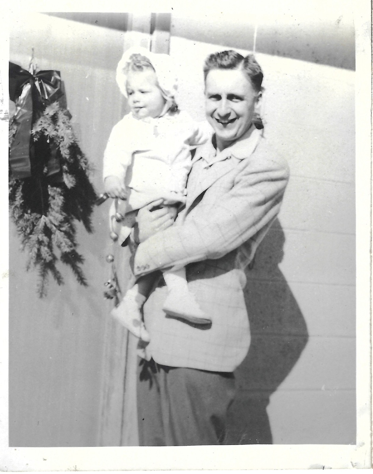 Jack holding Betty beside a decorated doorway