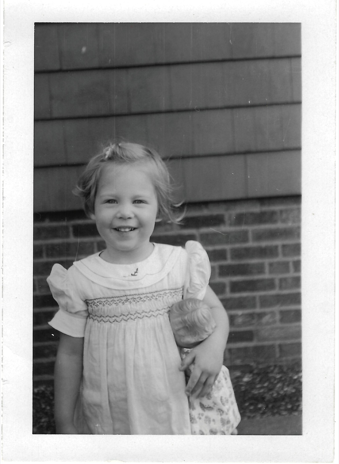Young Betty holding a doll