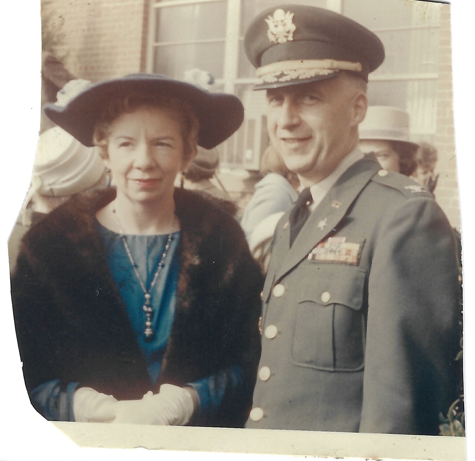 Woman and uniformed man outdoors
