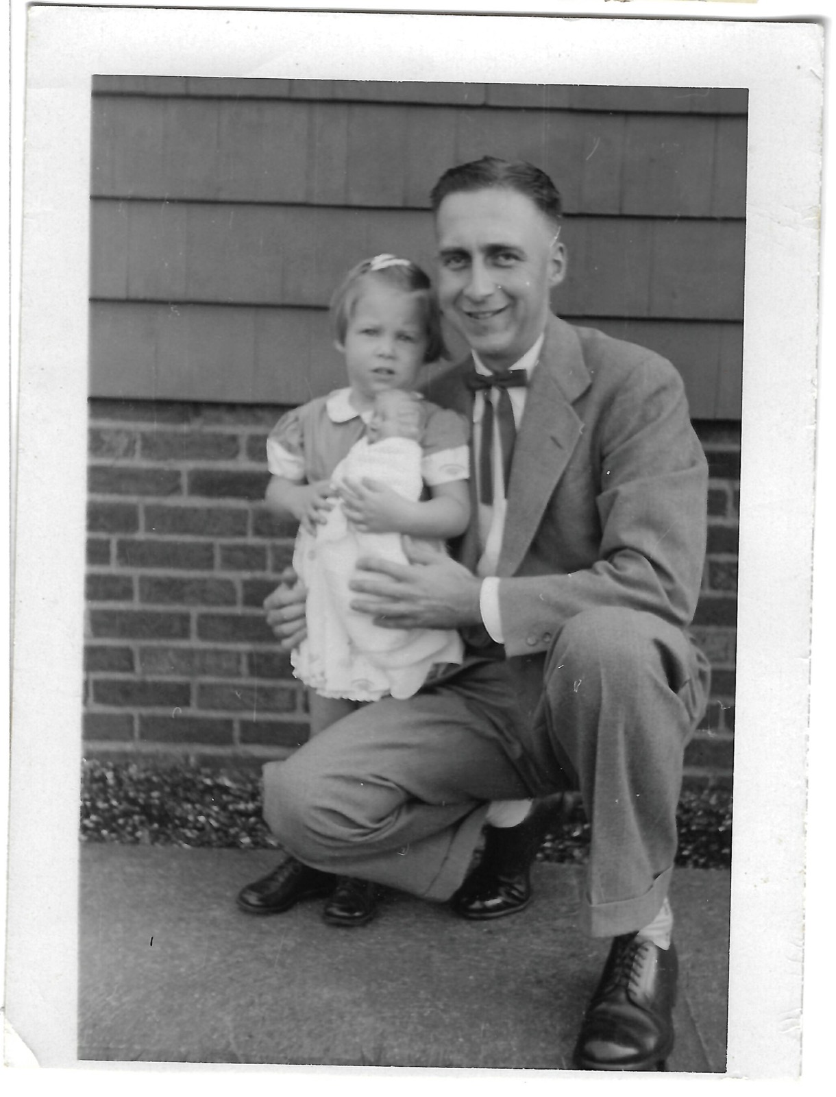Betty and Jack beside a house