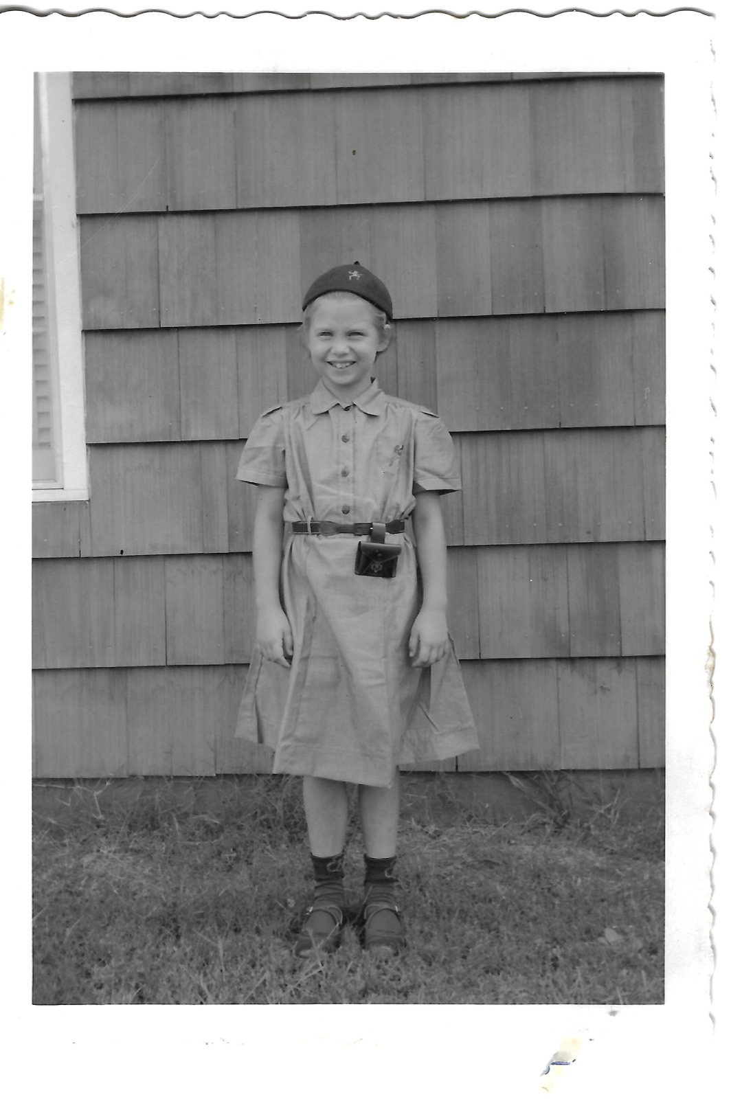 Betty wearing a cap and carrying a camera