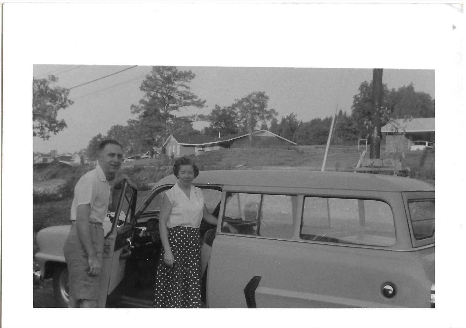 Two people beside car
