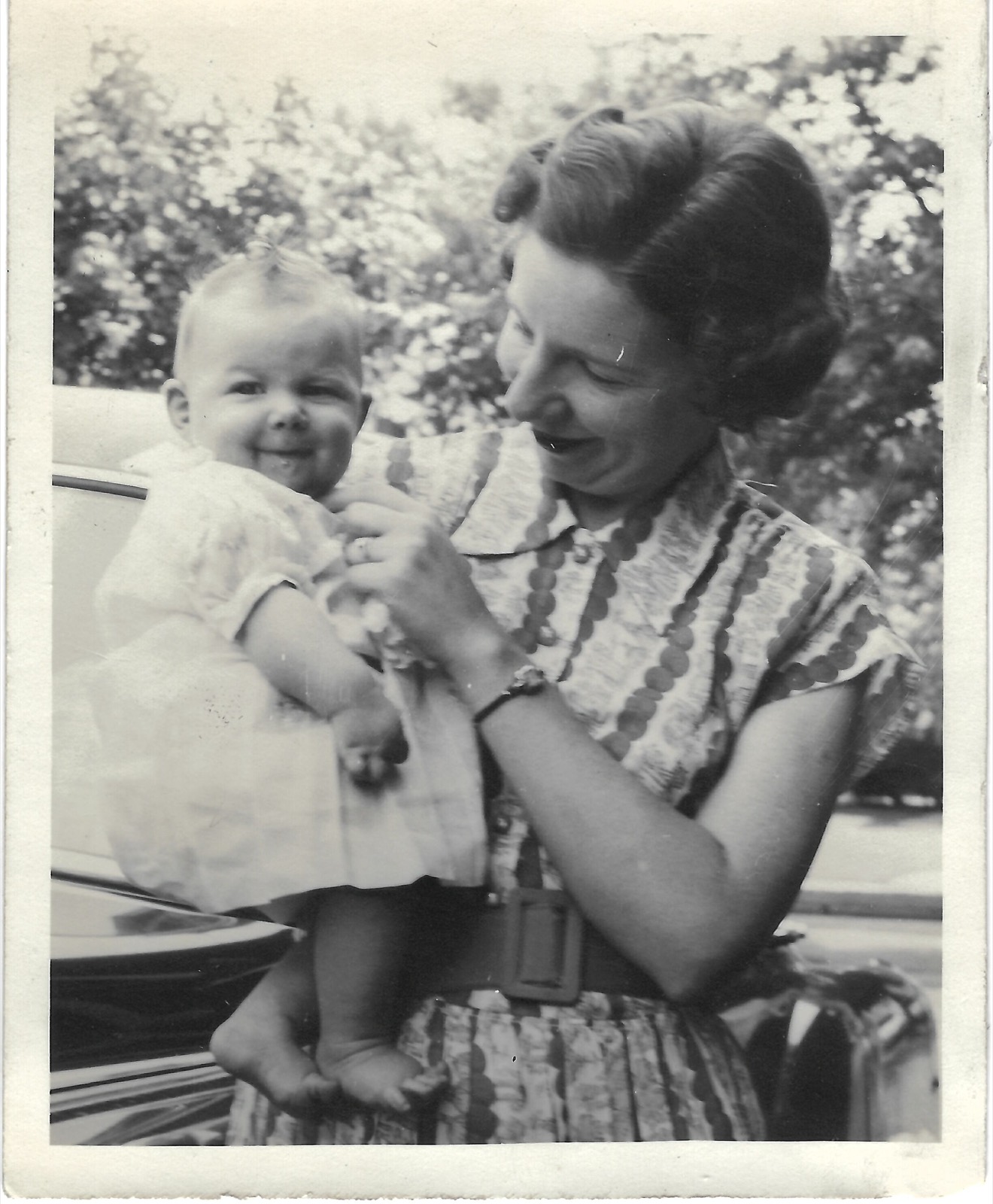 Jean holding baby Betty outdoors