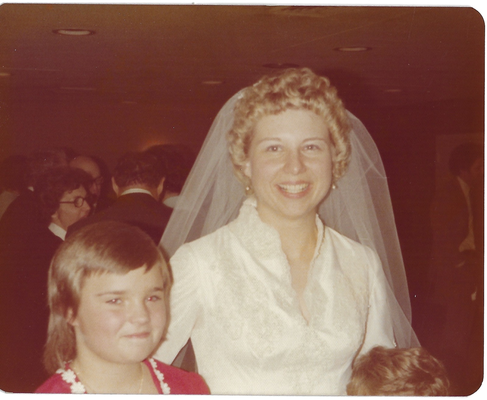 Betty with a child at a wedding