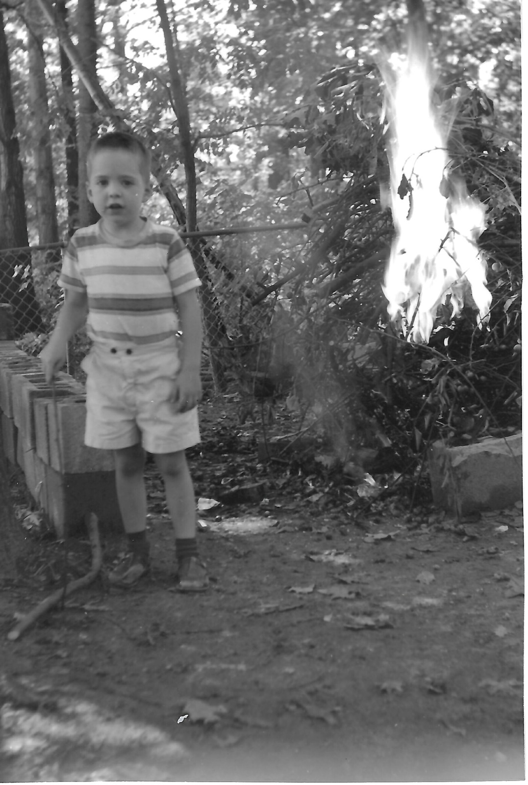 Young Bill beside trees