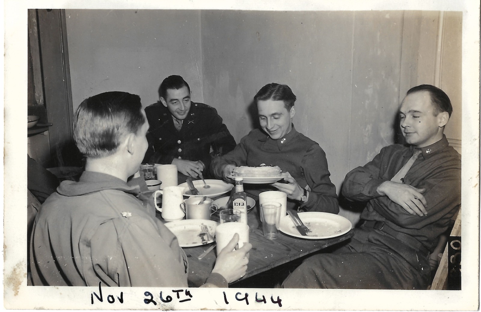 Jack seated with a wartime group at a table, November 26, 1944.