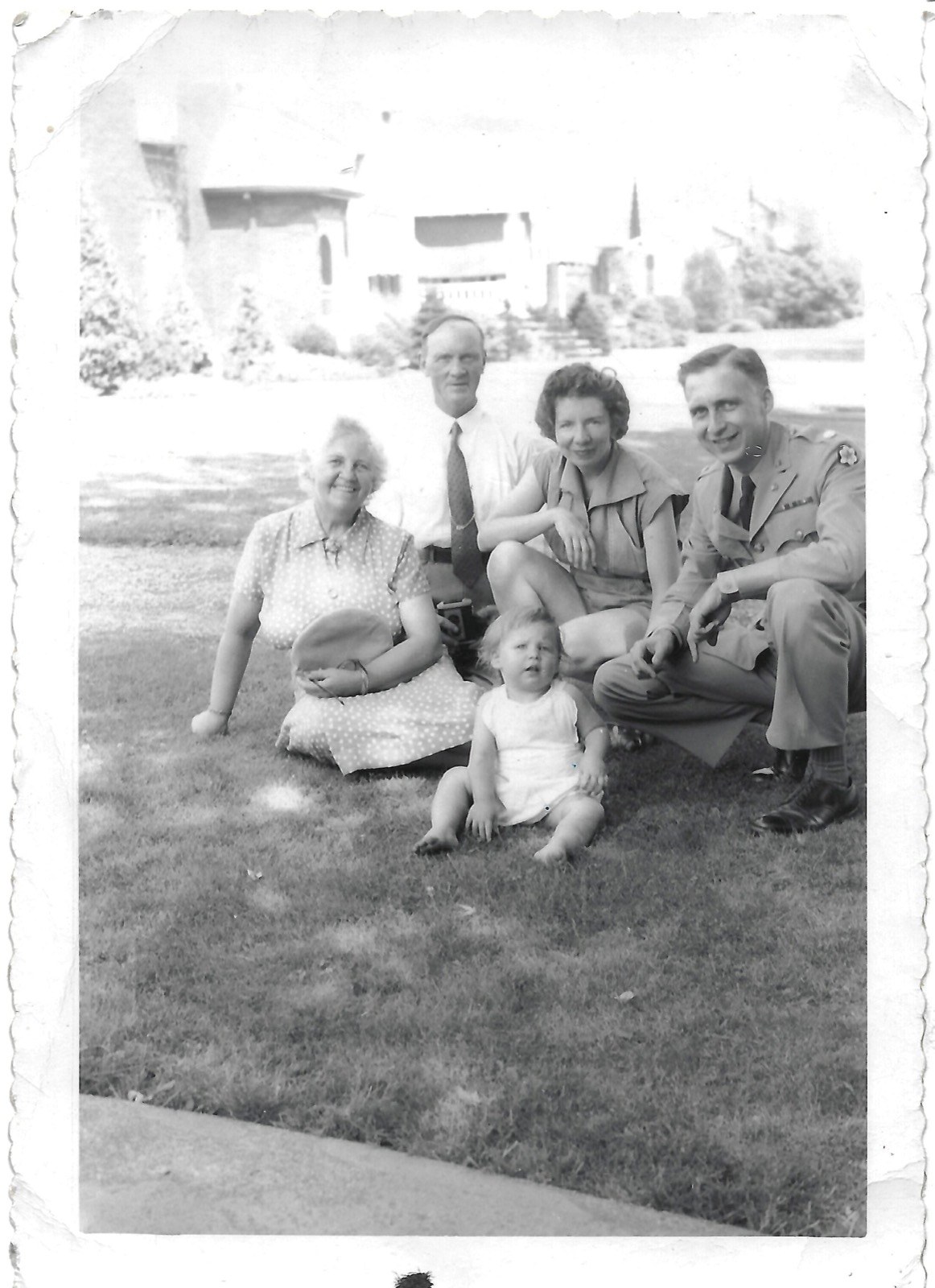 Family seated on lawn