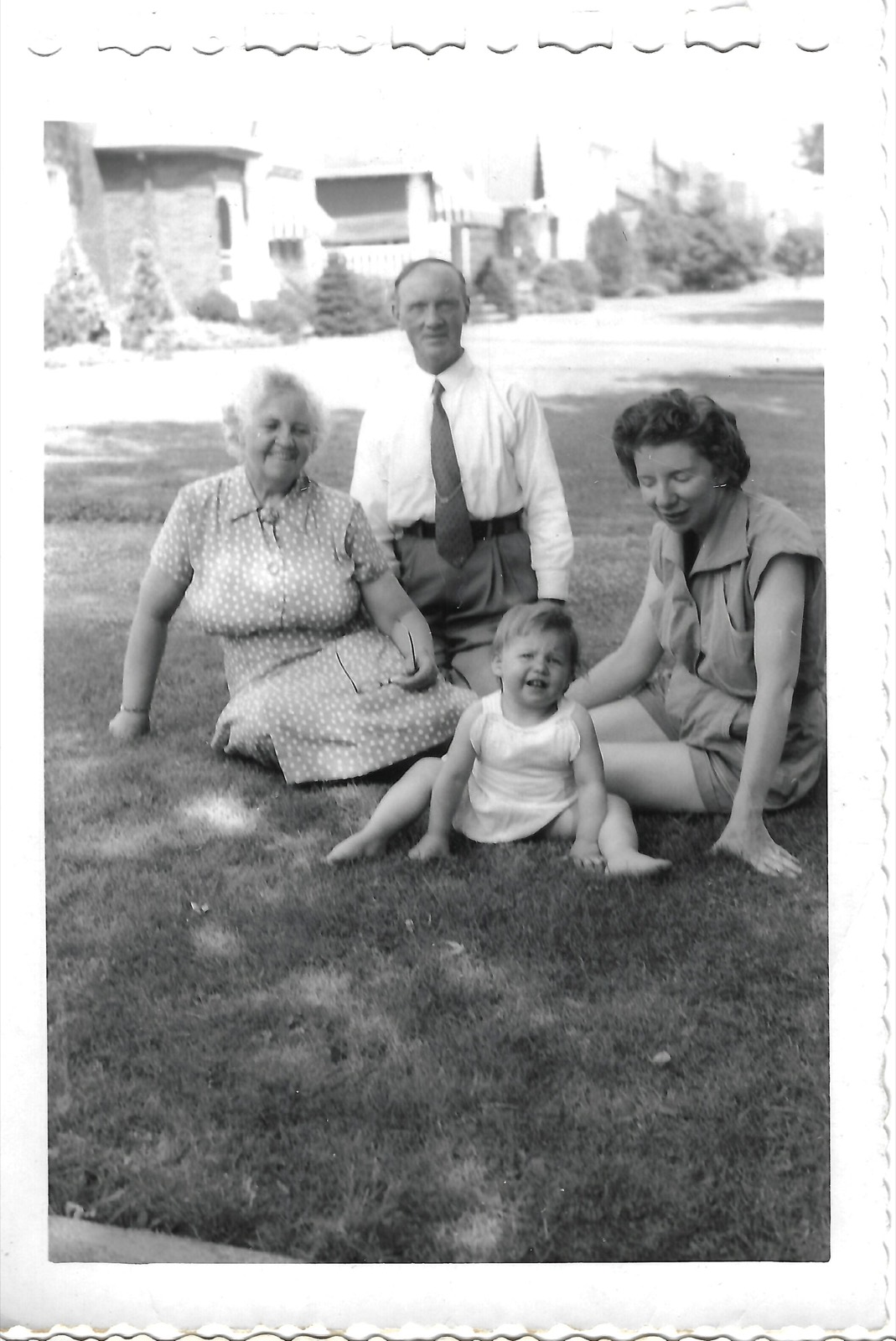 Nana, Paw, Betty, and Jean seated on a lawn