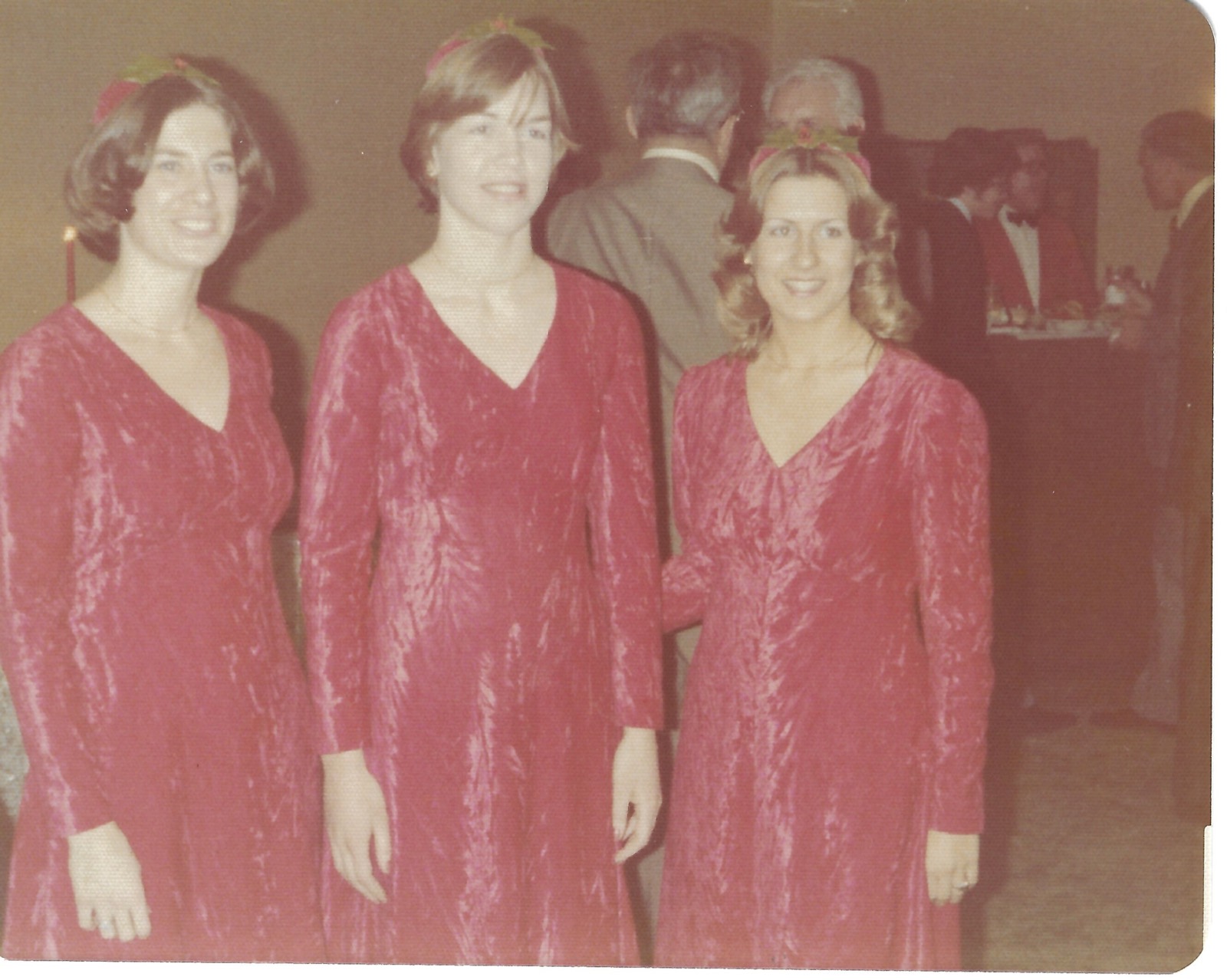 Three bridesmaids in matching red dresses