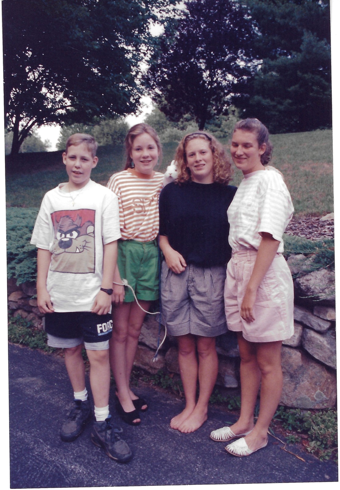 Four young family members outdoors