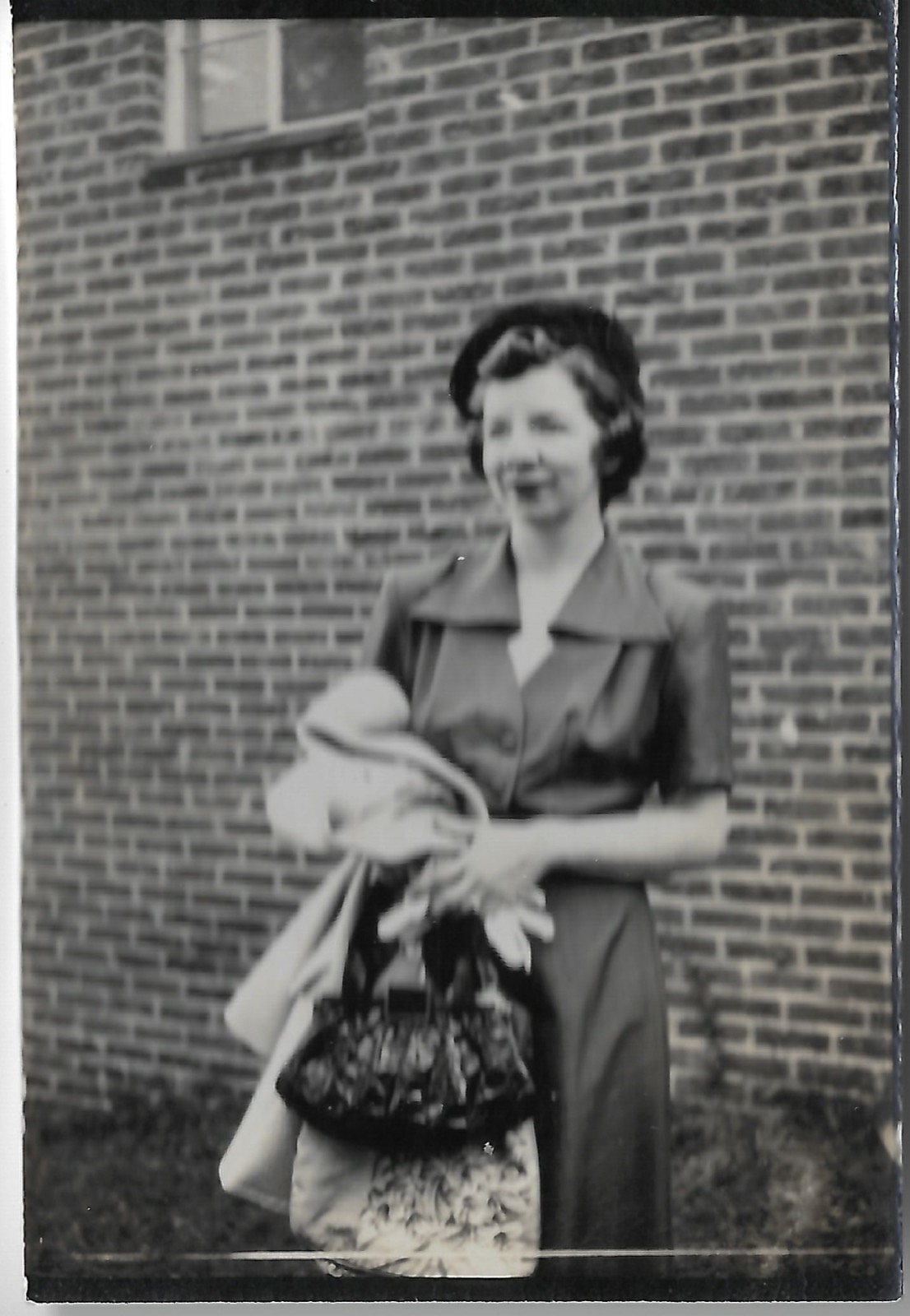 Jean holding a hat and bag