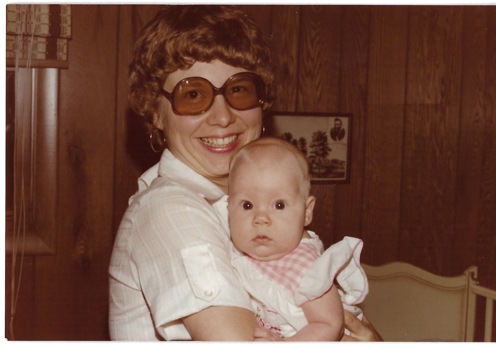 Betty holding Eileen indoors