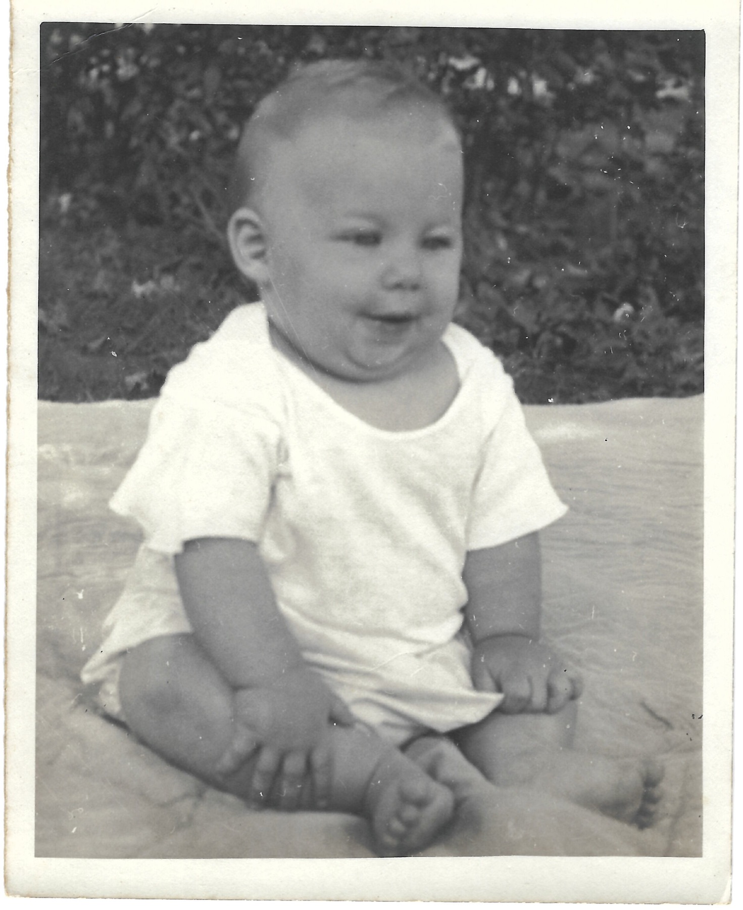 Baby Betty seated outdoors
