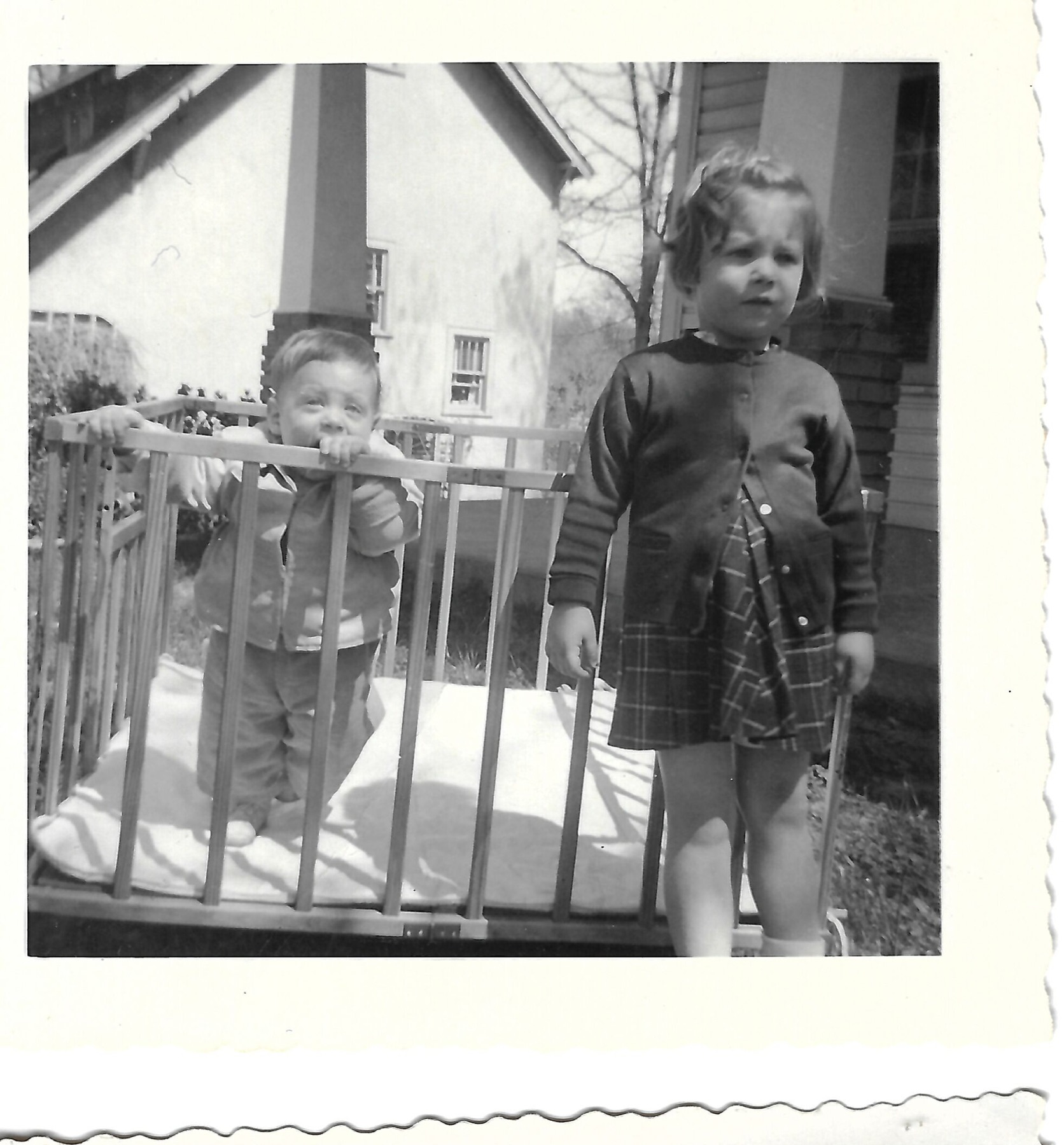 Betty and Bob beside a playpen