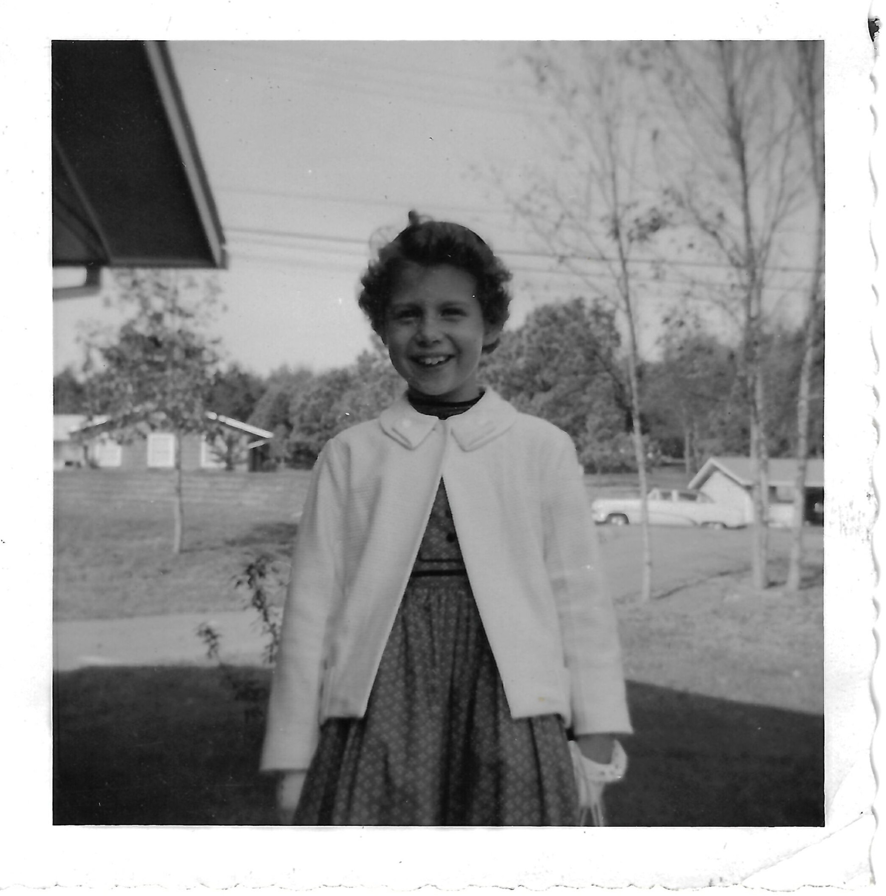 Betty outdoors in a cardigan