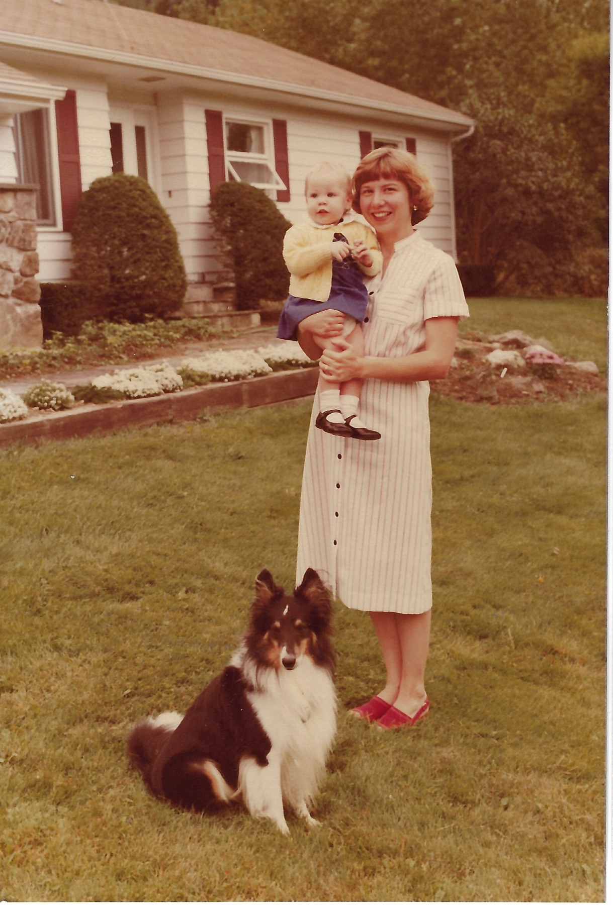 Betty and Eileen with Lance outside their home