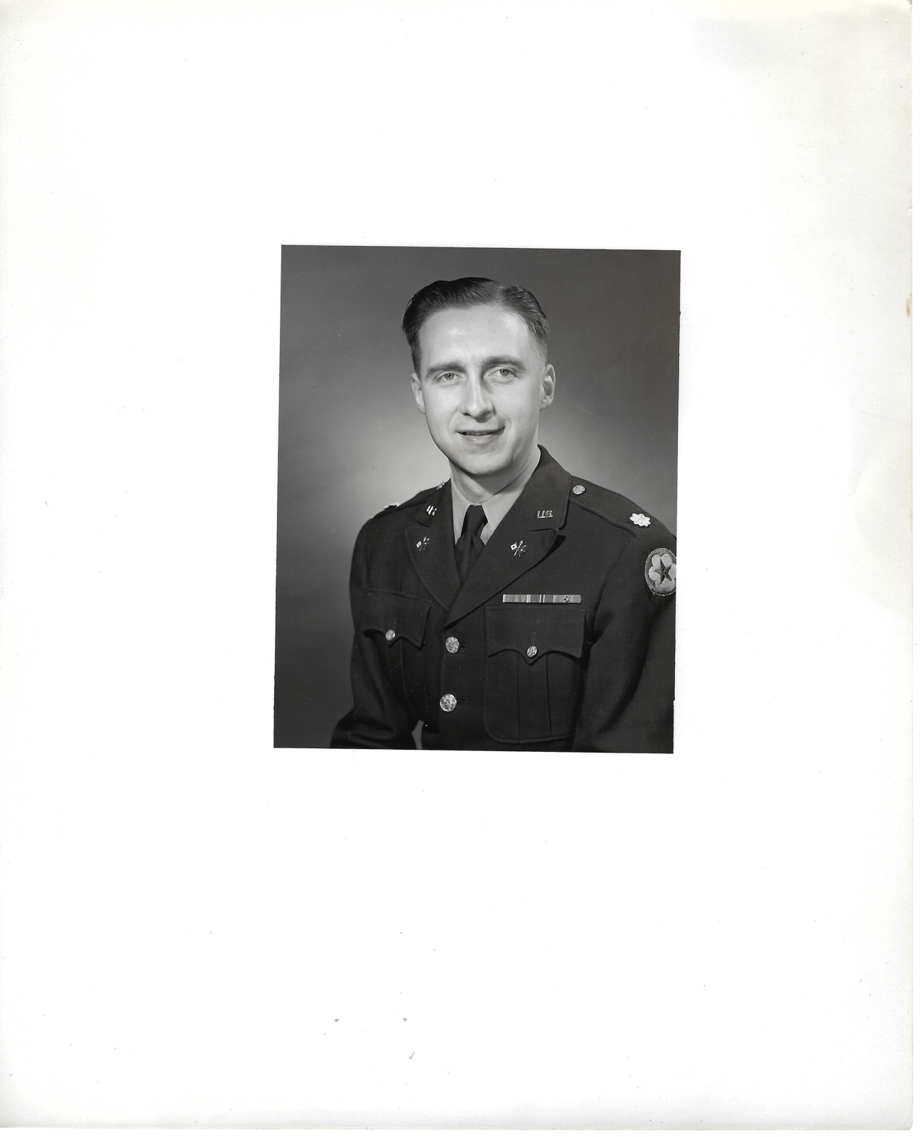 Jack Newman in uniform, 1951; straight-on portrait on a large white mount.