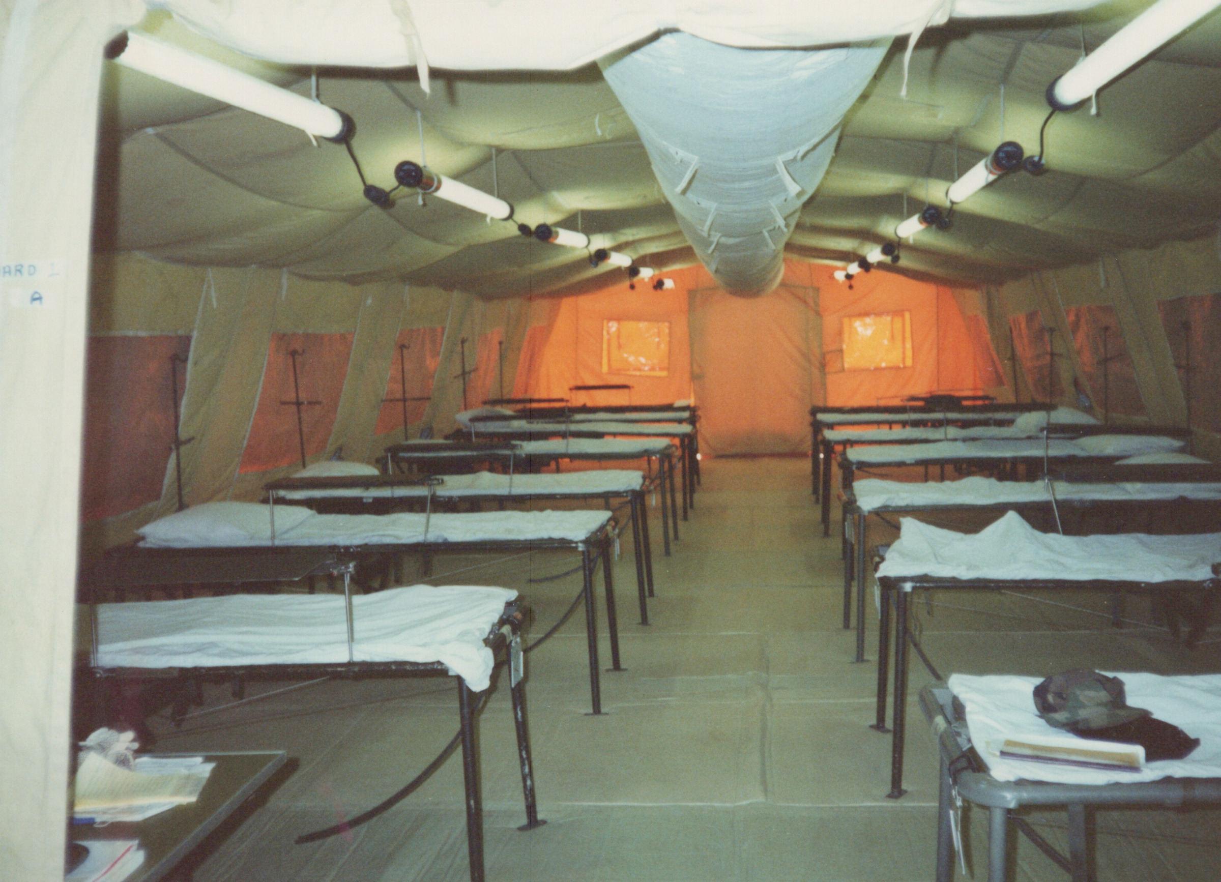 Fleet Hospital 007: Rows of prepared beds inside a tented ward.