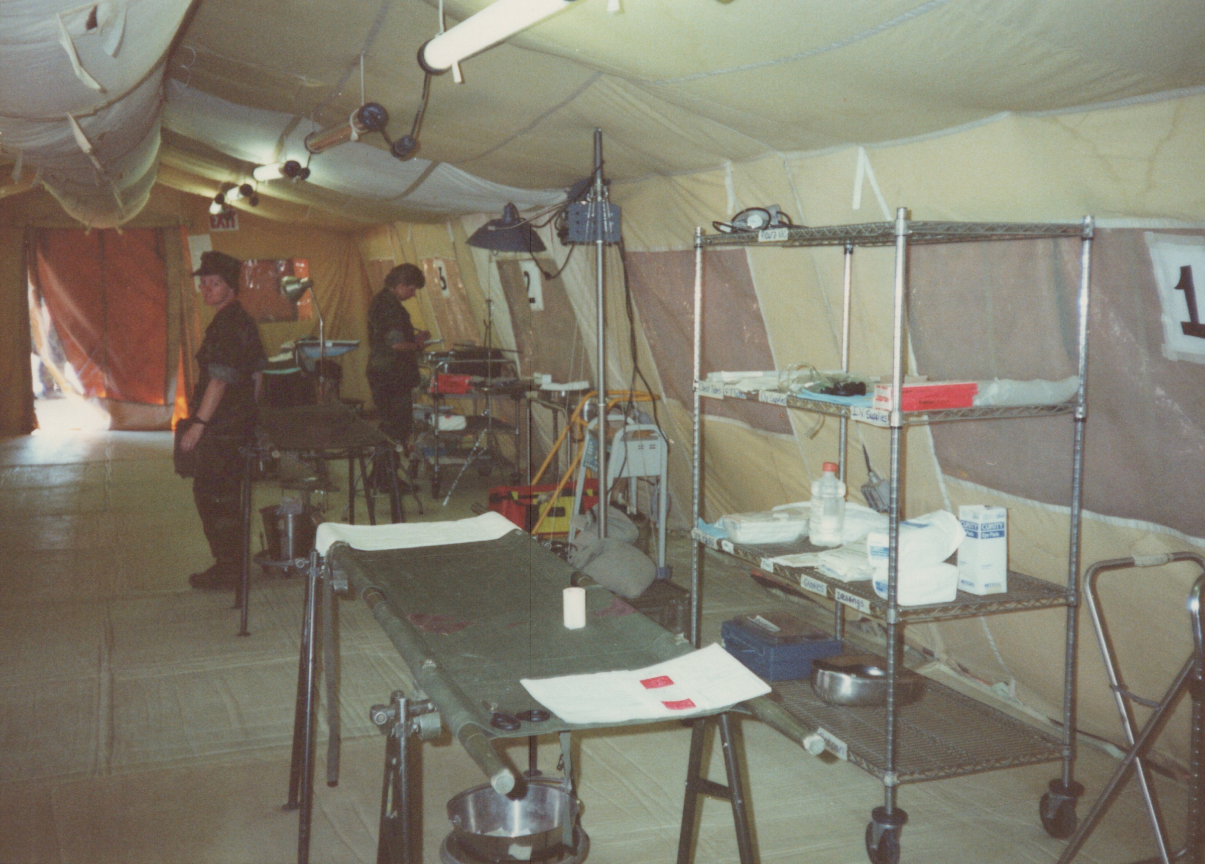 Fleet Hospital 007: Personnel and equipment inside a tented care area.