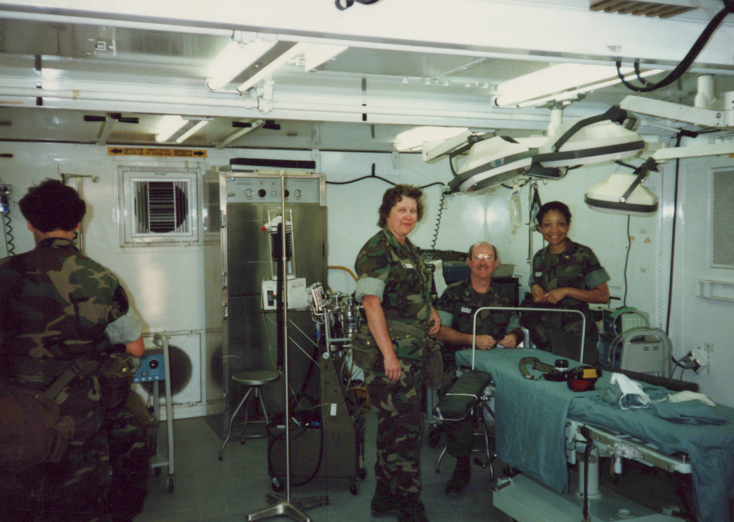 Fleet Hospital 007: Personnel with beds and equipment inside a modular clinical unit.