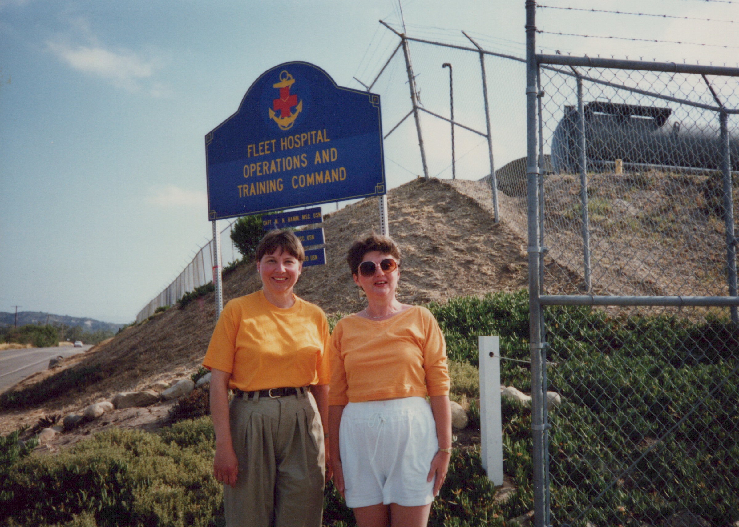 Fleet Hospital 007: Two people beside a Fleet Hospital training-command sign.